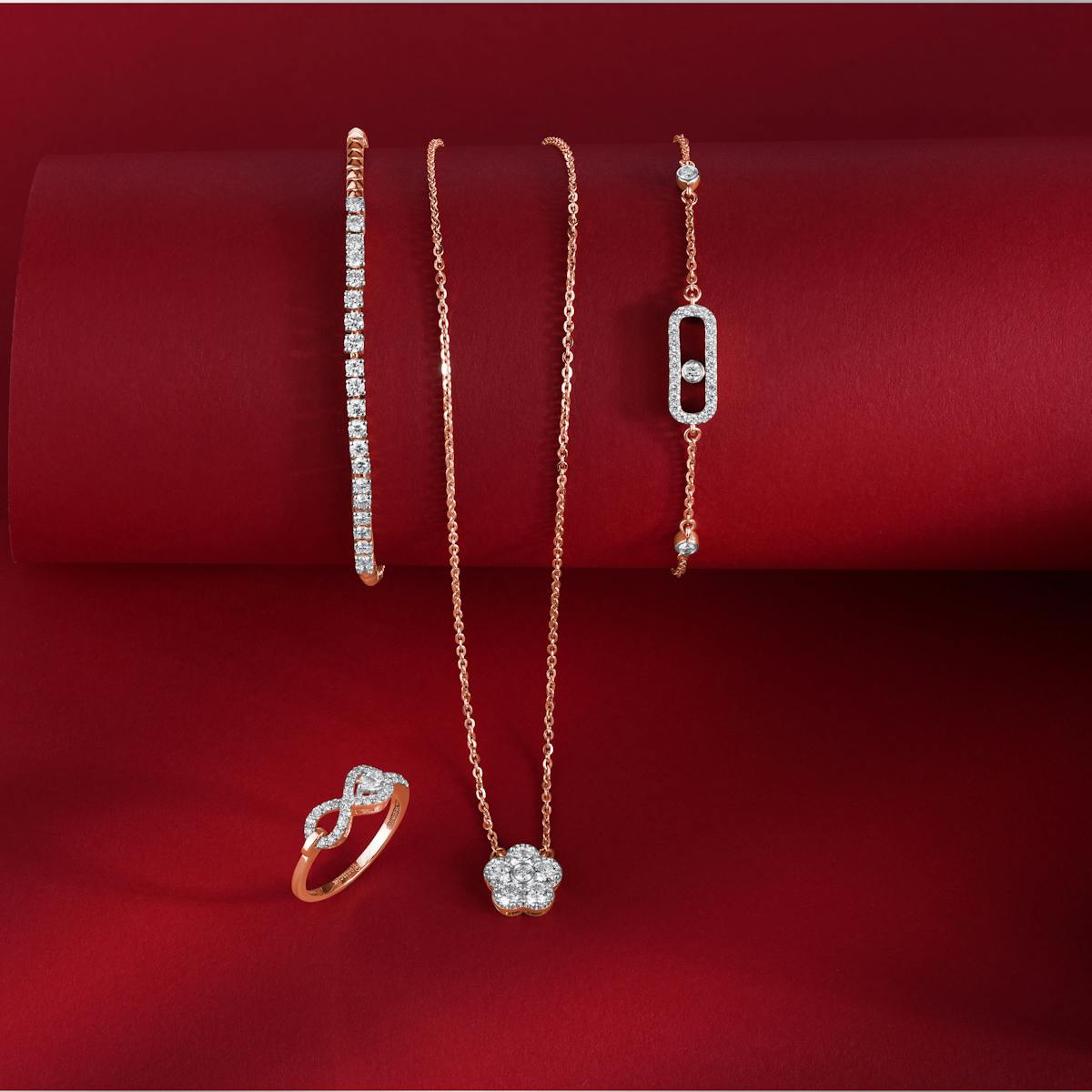 Beautiful rose gold and diamond jewelry set against a luxurious red background.